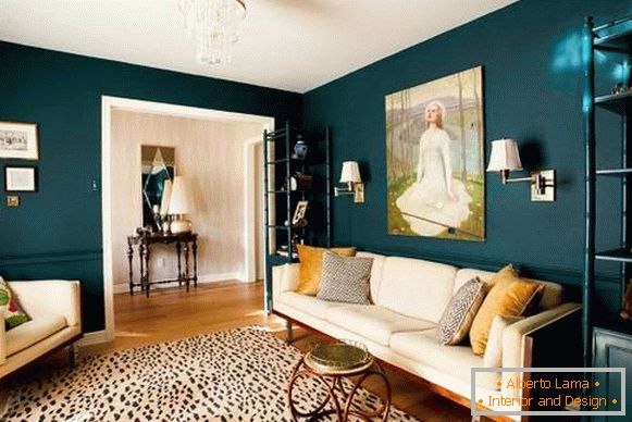 The dark green color of the walls in the living room