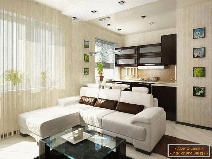 Worthy of attention is the interior of a spacious, bright kitchen-studio. Well-chosen furniture, a combination of the basic colors of the room, an abundance of light from the spacious windows, lighting design, and lovely pictures on the walls.