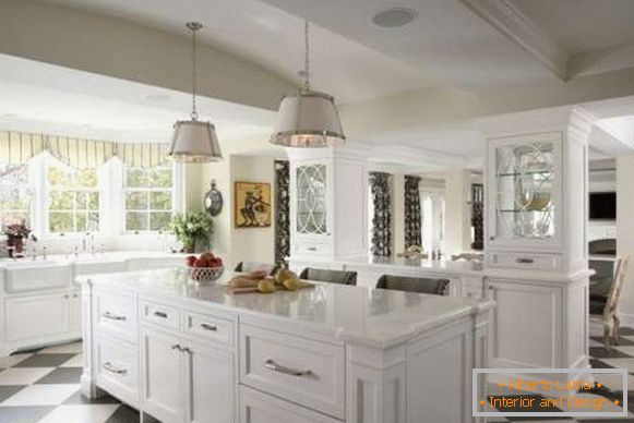 Interior of a large kitchen in a private house with a sink near the window - photo