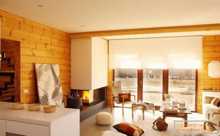 Modern fireplace with a chimney in the eco house made of glued beams. 