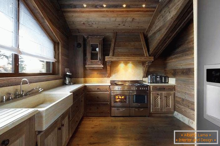 Restrained design of the kitchen in the Alpine style is decorated in a single color.