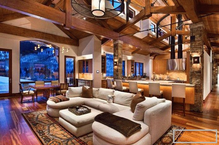 Living room in a spacious house. The original ceilings of wooden beams are becoming