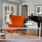 Orange armchair in a strict interior