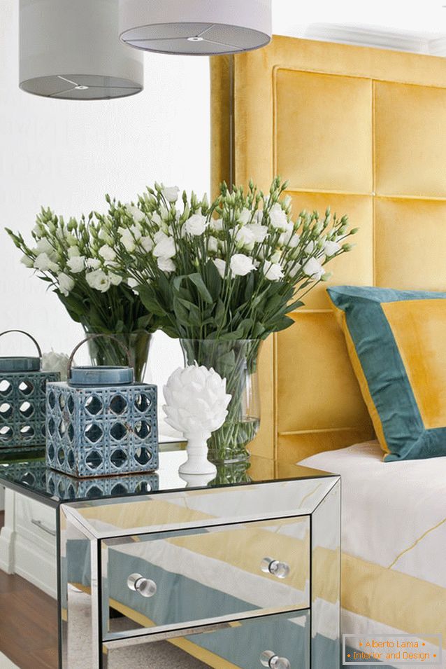 Flowers in the bedroom of a bright studio apartment in Russia