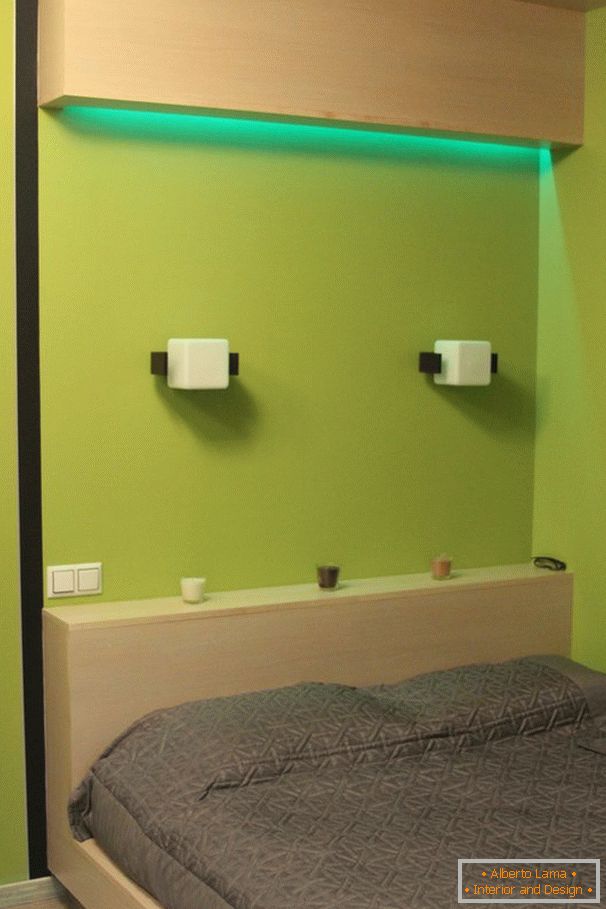 Green light above the bed in the bedroom