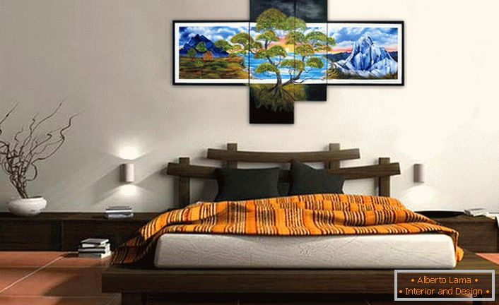 The bedroom in the oriental style is decorated with modular paintings that weigh on the head of the bed.