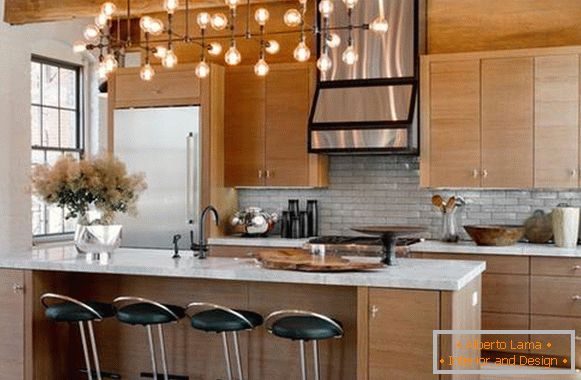 Brick wall and loft fixtures in the interior of the kitchen