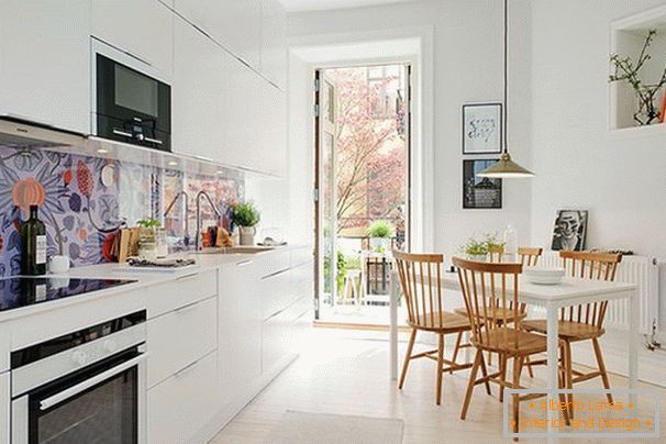 Kitchen interior in Scandinavian style with balcony