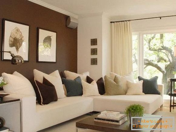 Dark brown walls in the design of the living room with a white sofa