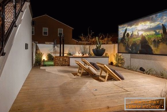An outdoor terrace attached to the house - a photo with a projector