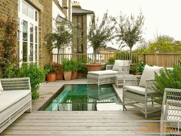 Outdoor terrace attached to the house with a swimming pool - photo
