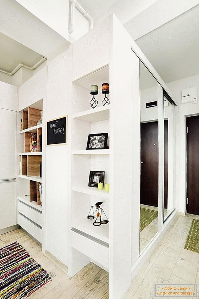 A shelf with accessories and a mirrored wardrobe in the hallway