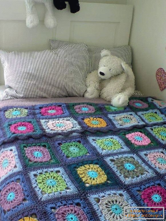 Knitted bedspread for a bed in a nursery in the style of patchwork