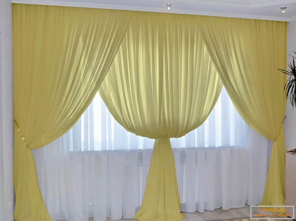 Yellow curtains and white tulle in the room
