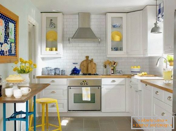 Interior of a small kitchen with corner cupboards and a bar counter - photo