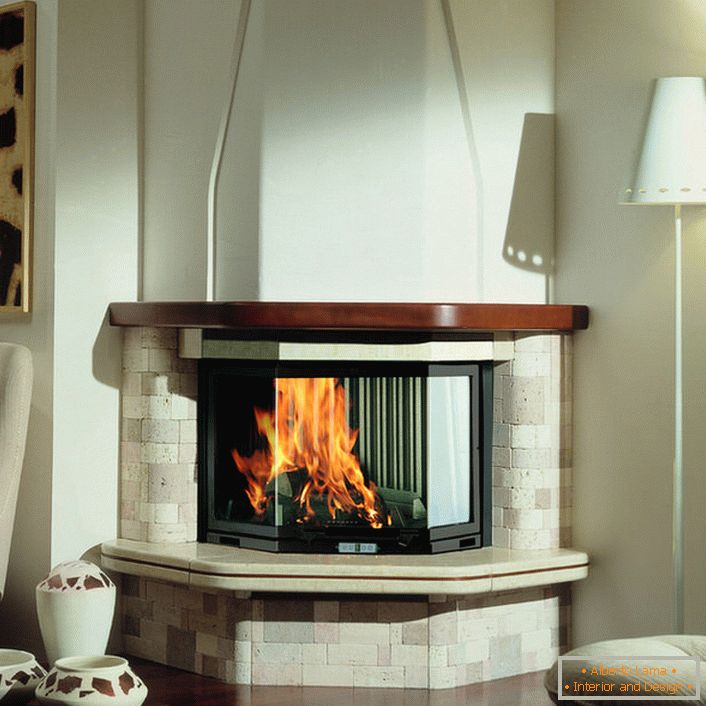 The corner fireplace successfully blends in with the interior of the warm Mediterranean style. Chimney and portal of light brick create a calming mood. spacious living room