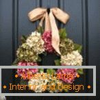 Festive wreath at the door of spring flowers