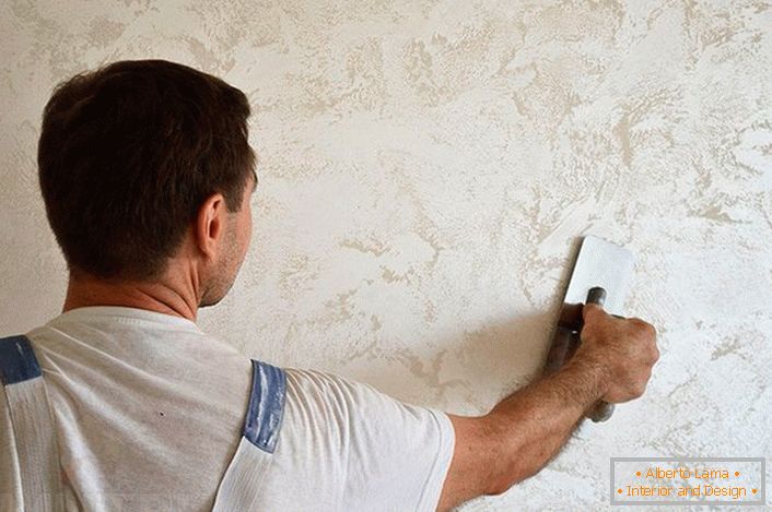 On the walls, Venetian plaster is applied in thin layers (at least three). Each layer is smeared in chaotic order.