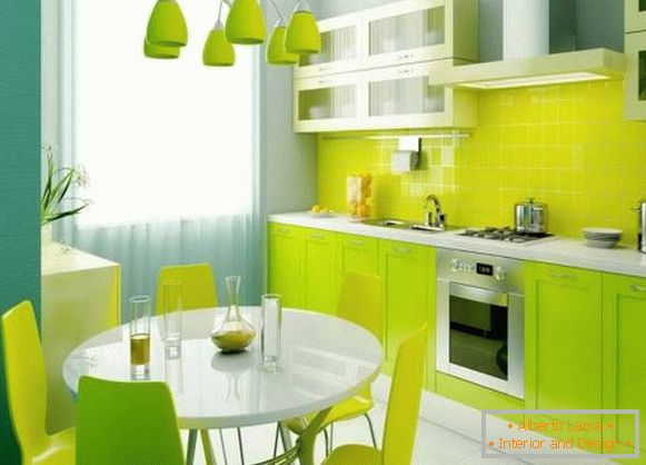 Beautiful green kitchen in the interior of the apartment