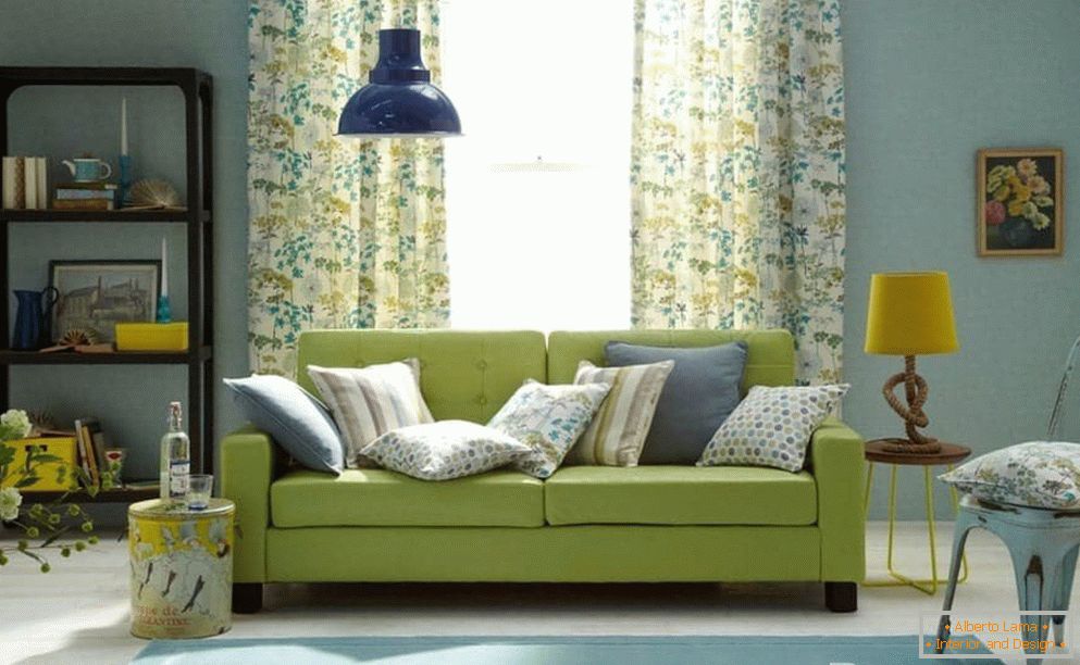 Living room in blue with a green sofa