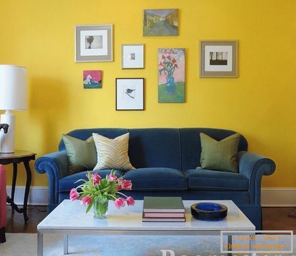 Blue sofa on a yellow wall background